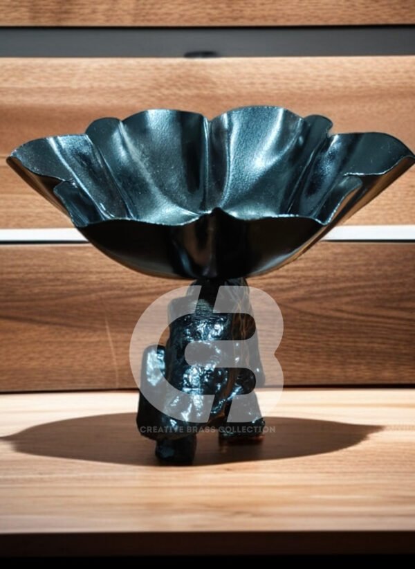 A high-resolution product shot of a handcrafted elephant bowl with colorful enamel details, used as a dry fruit dish. The elephant's trunk is raised in a symbol of good luck. Product code CB-ETLH01.